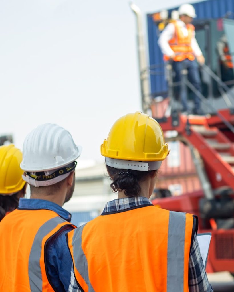 Foreman control loading Containers ship for Logistic planning and explain work to team of diversity